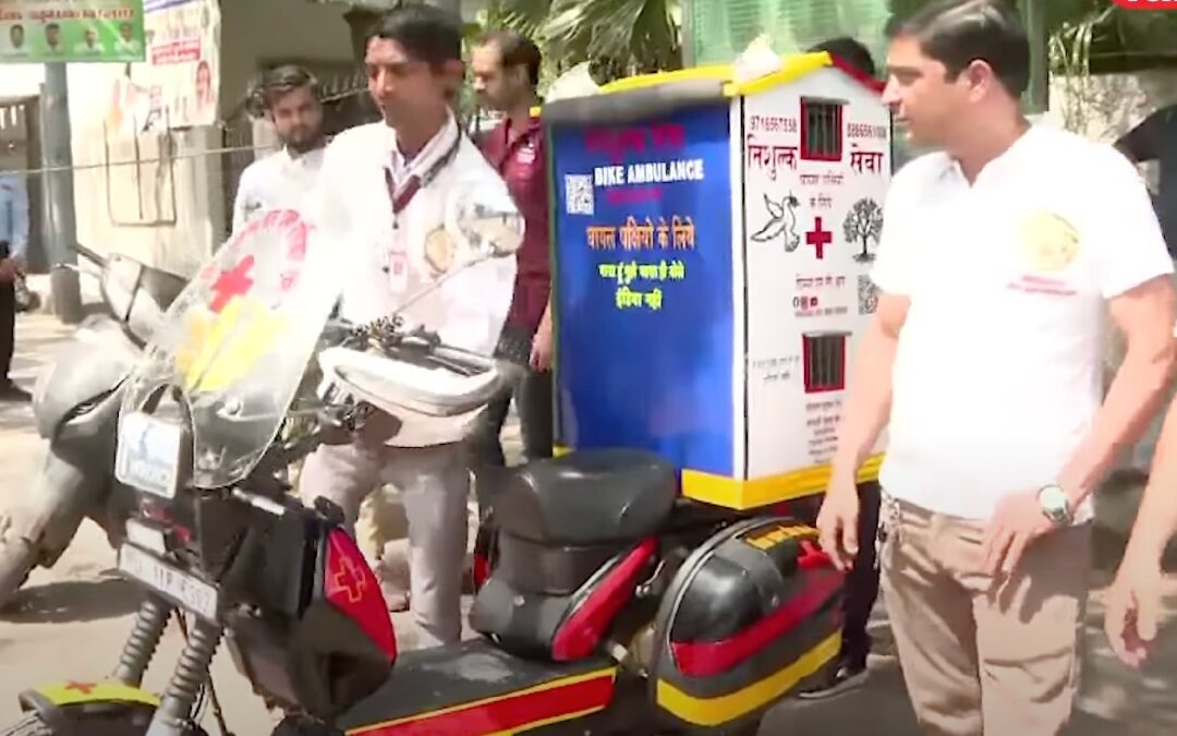 Jain brothers from Delhi, India, standing next to bird ambulance motorcycle for saving sick and injured birds
