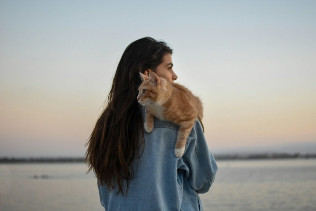 Cat on woman's shoulder, showing how cats improve mental health